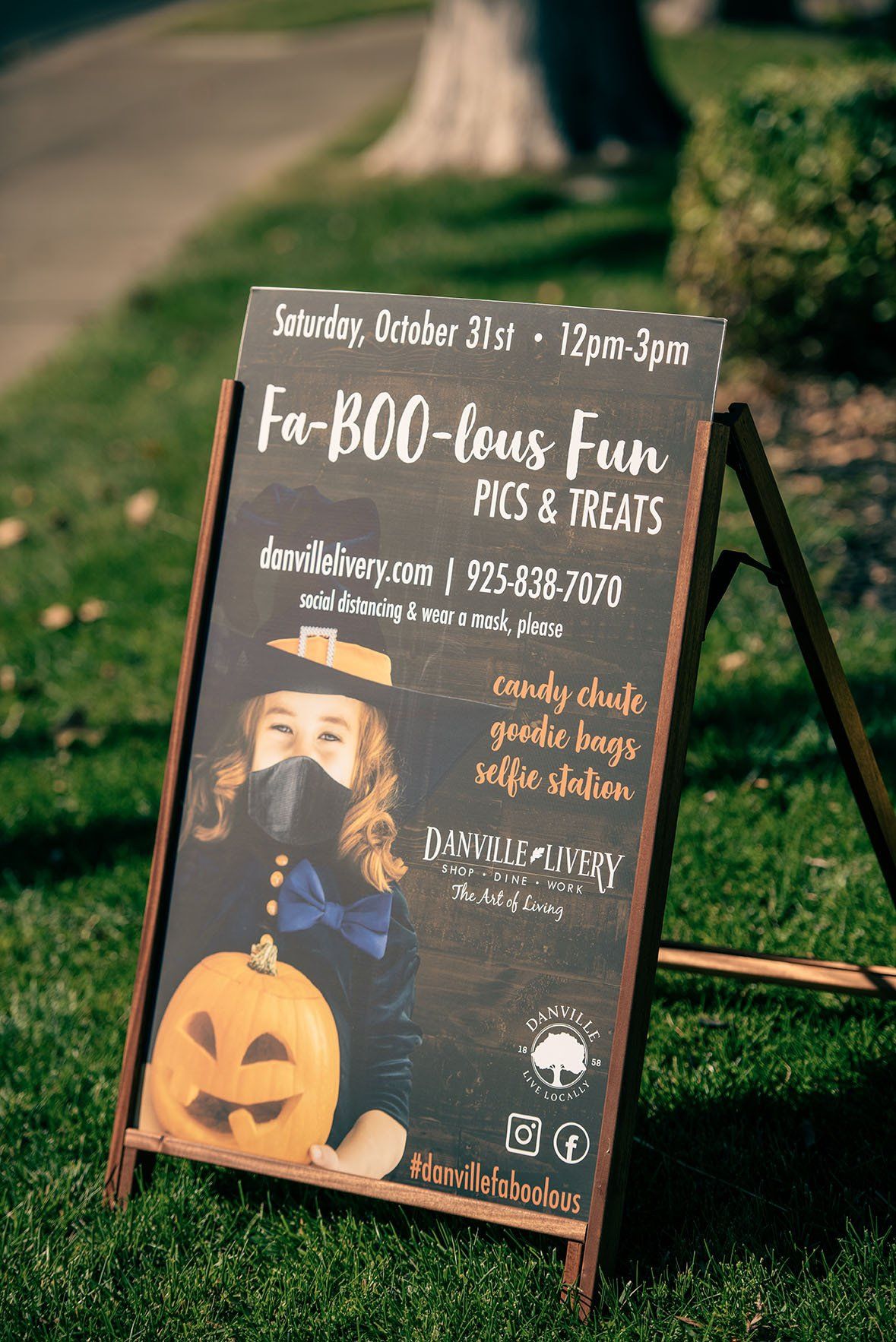 A chalkboard with a picture of a girl and a pumpkin on it.