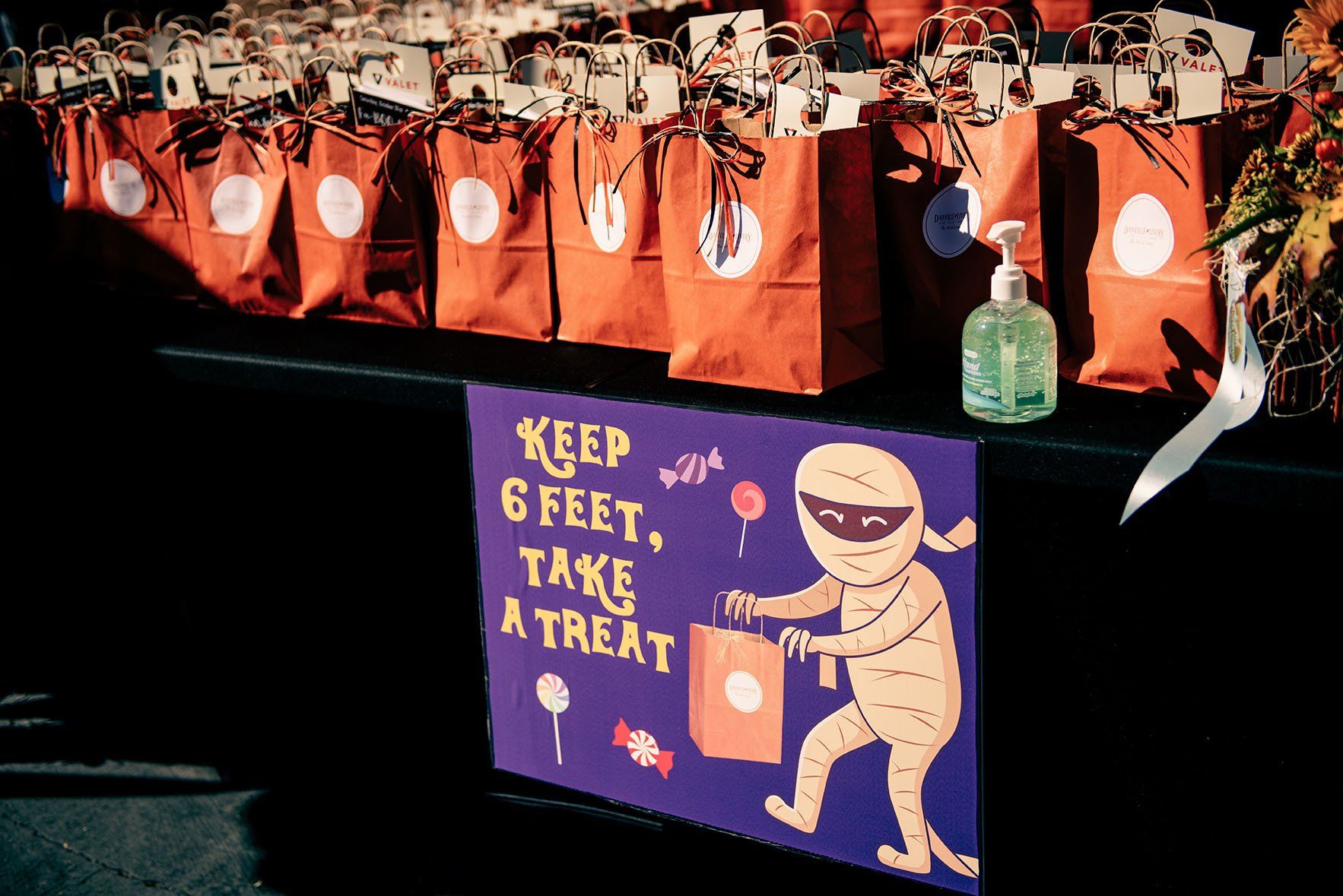 A sign that says keep 6 feet take a treat