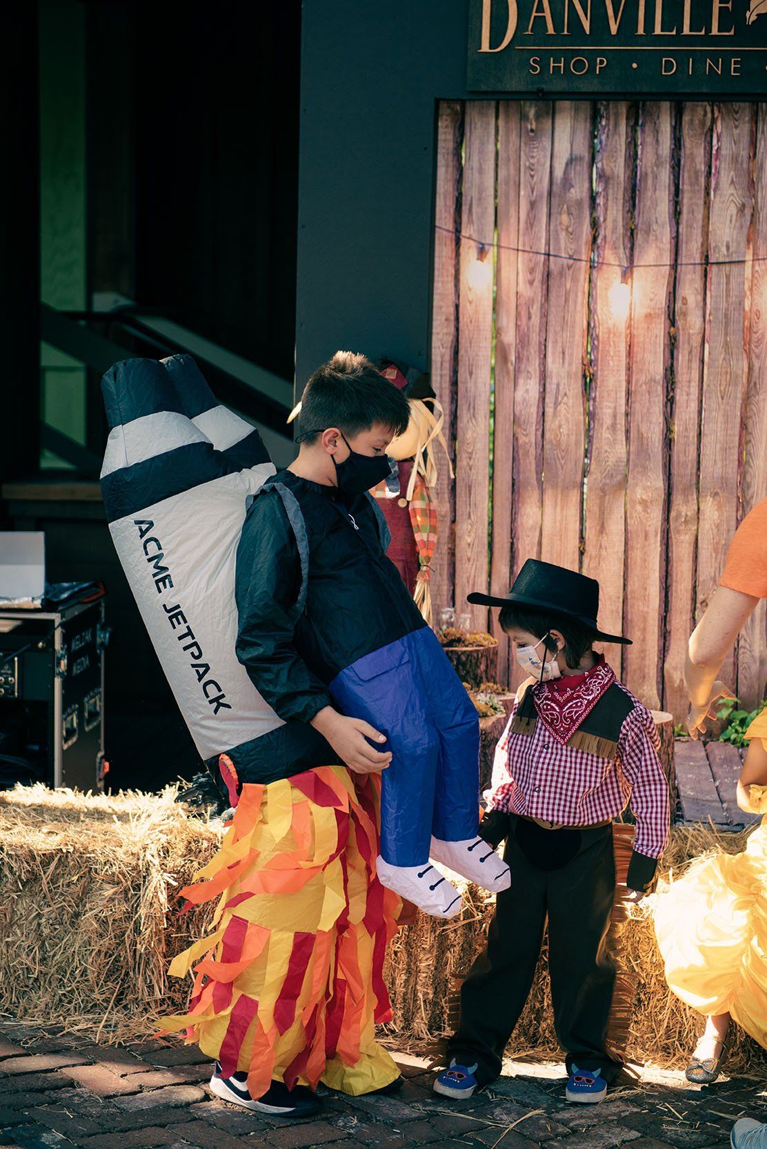 A man in a costume is carrying a child in his arms.