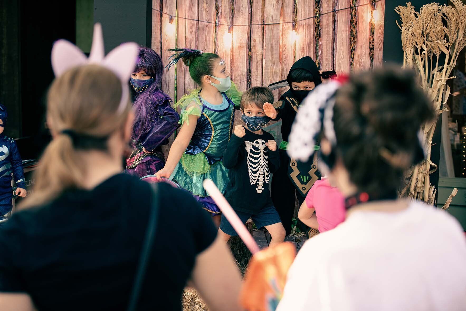 A woman is taking a picture of a group of people dressed in costumes.