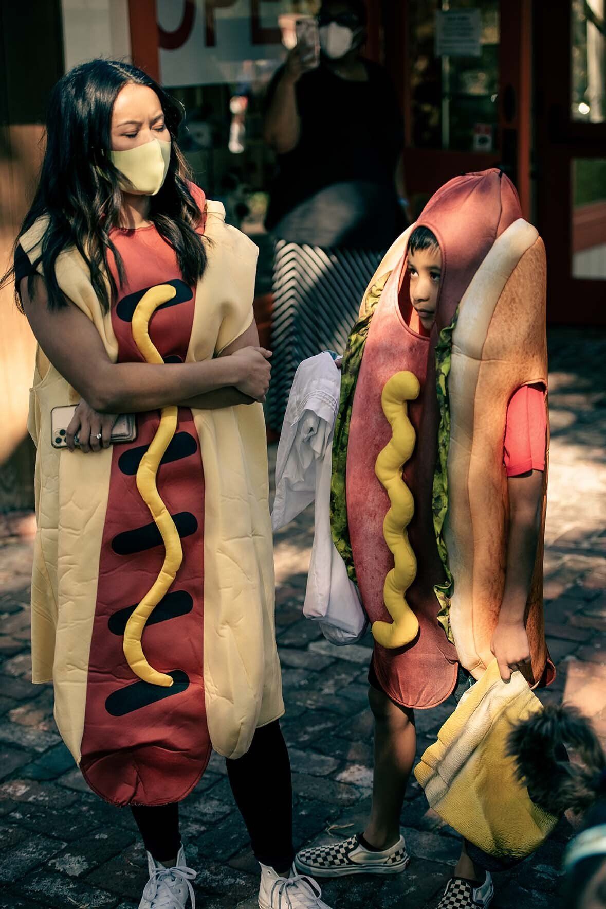 A woman and a child are dressed up as hot dogs.