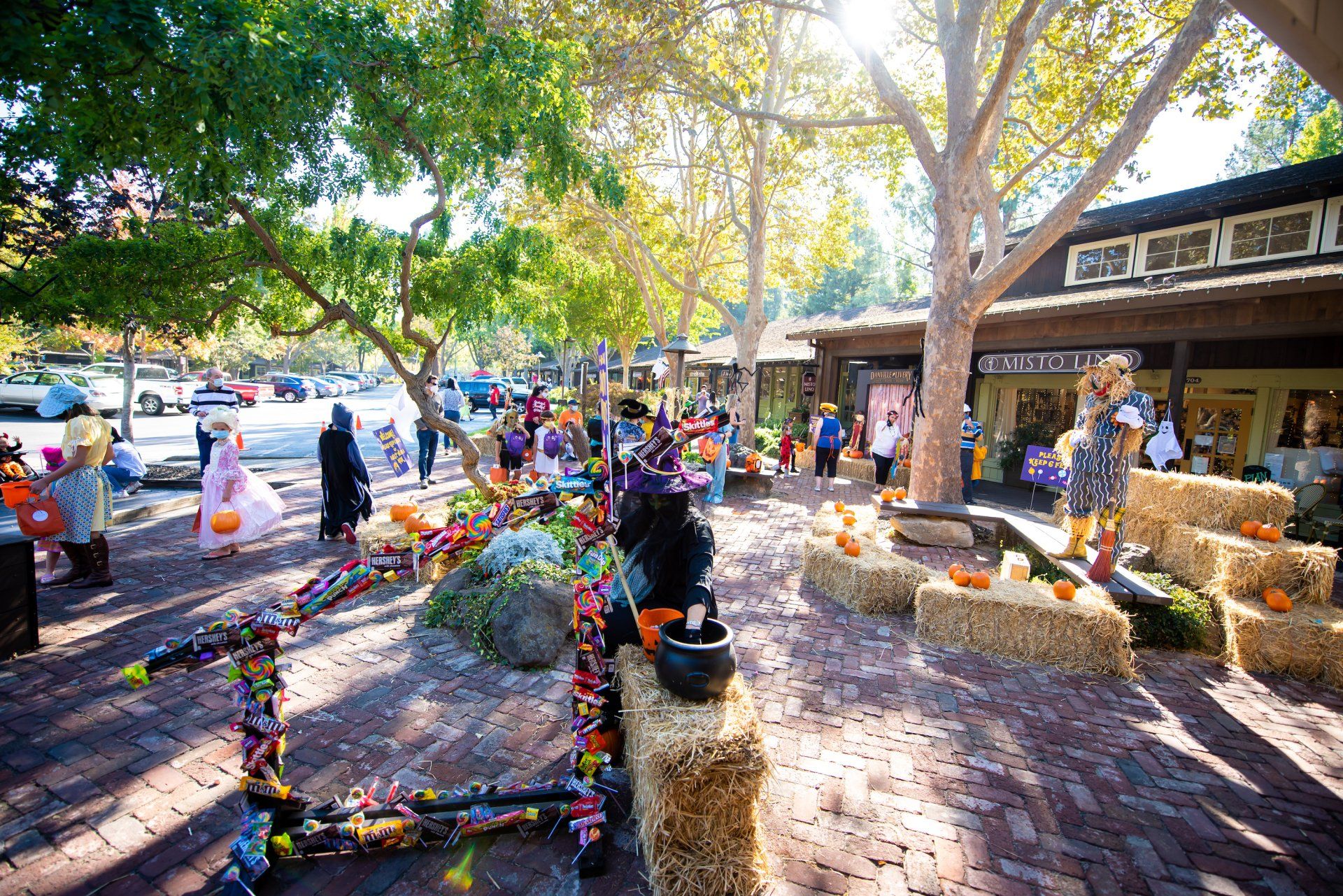 A group of people are standing in front of a building decorated for halloween.