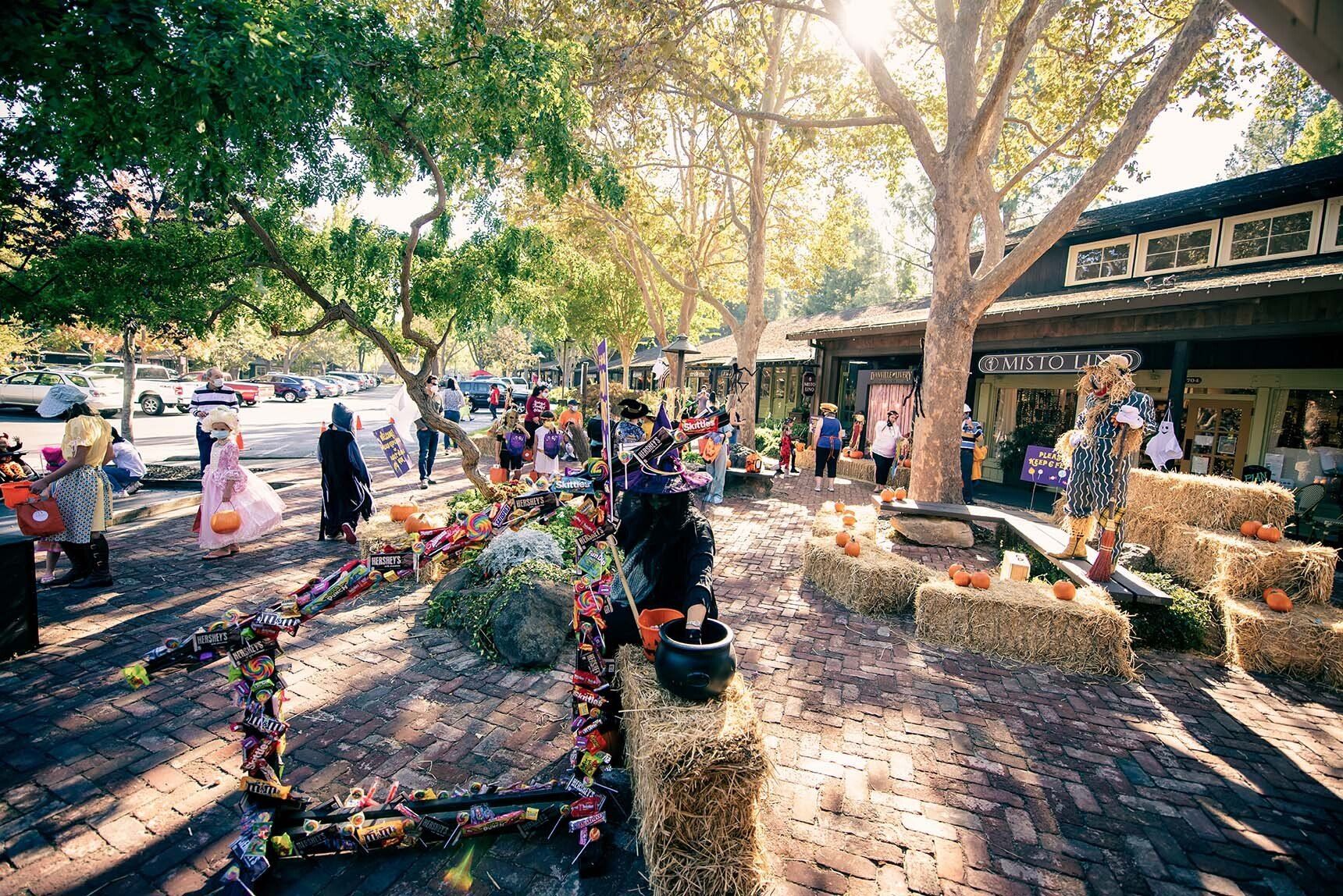 A group of people are standing in front of a building decorated for halloween.