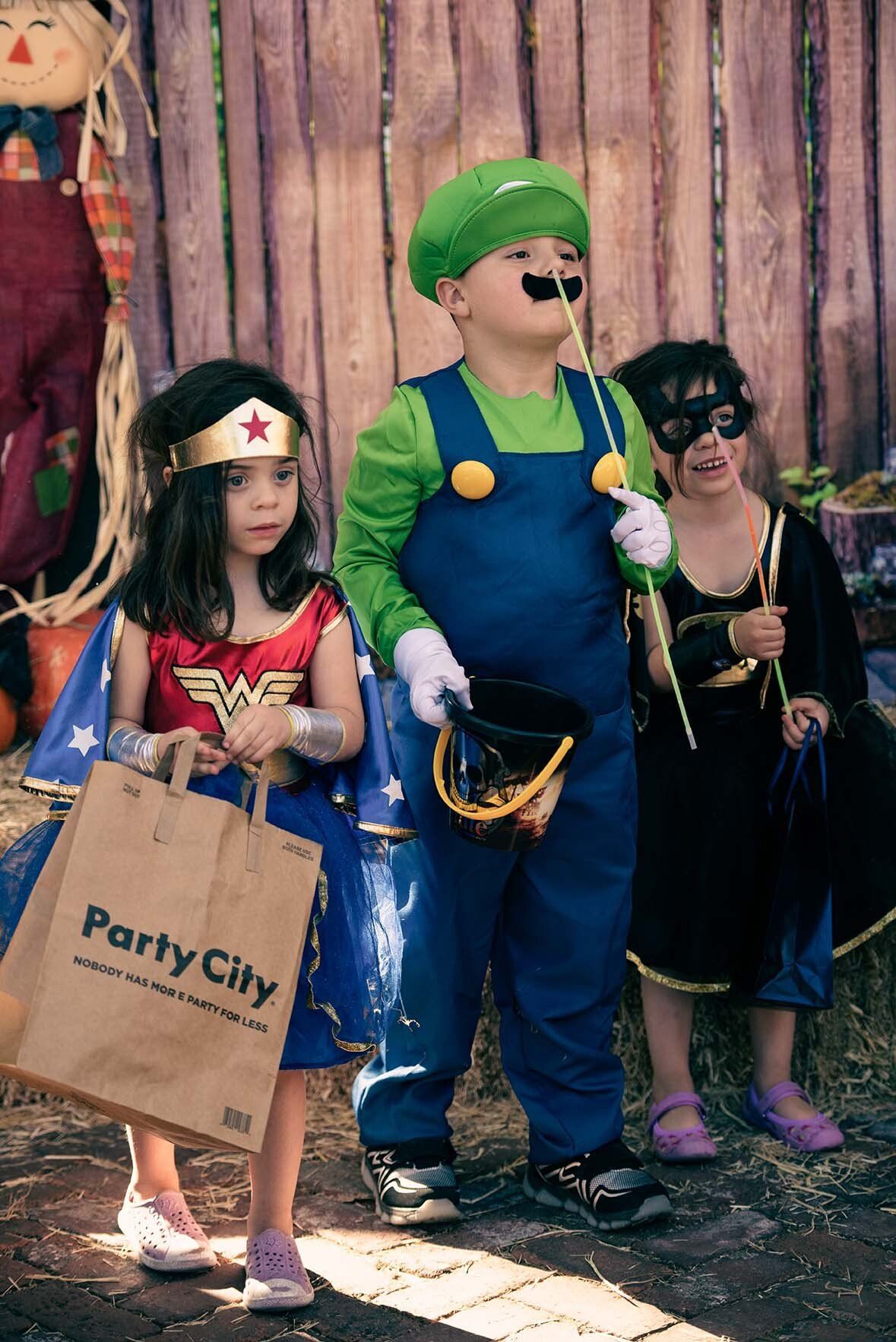 A group of children dressed in costumes are standing next to each other.