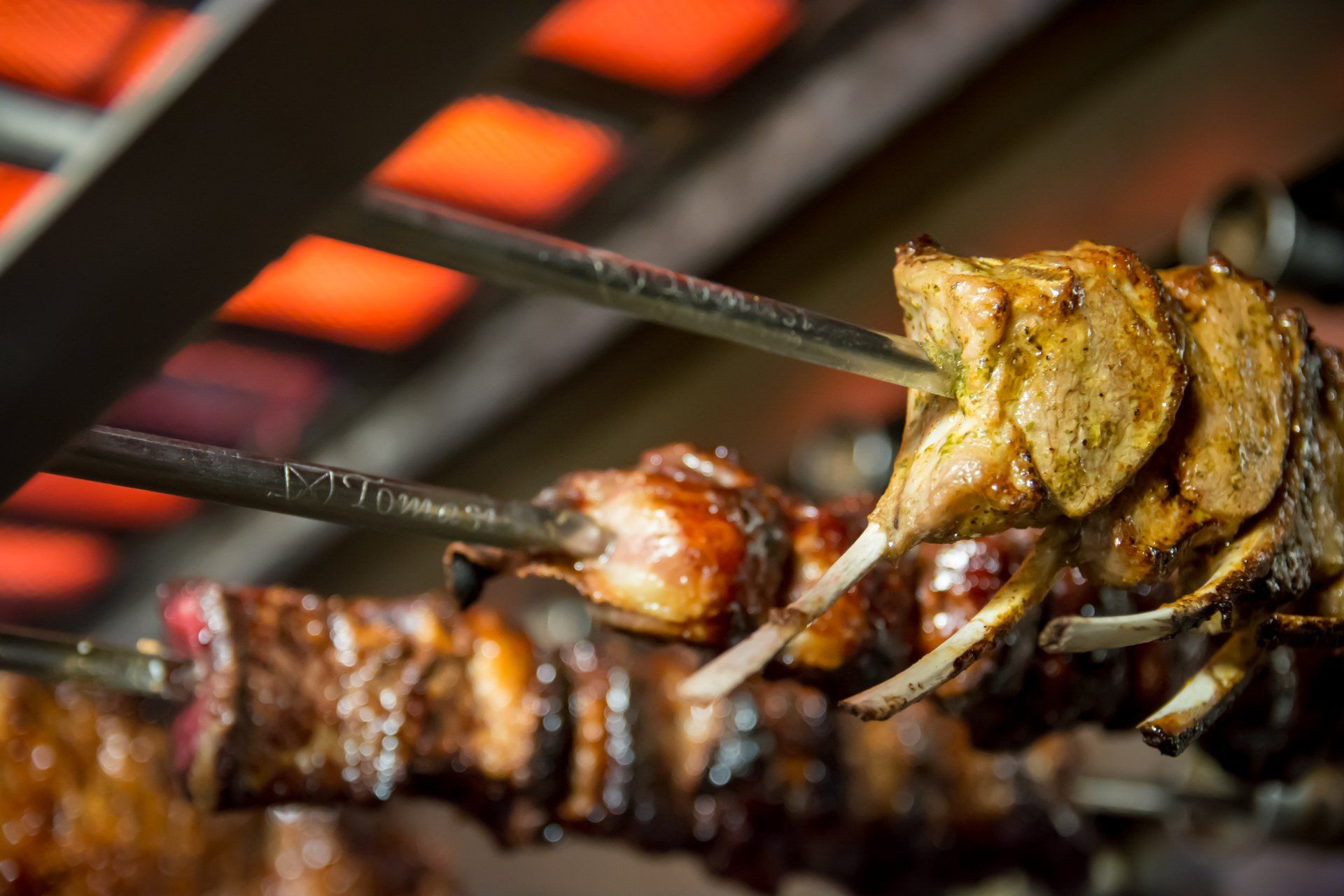 A close up of meat being cooked on a grill.