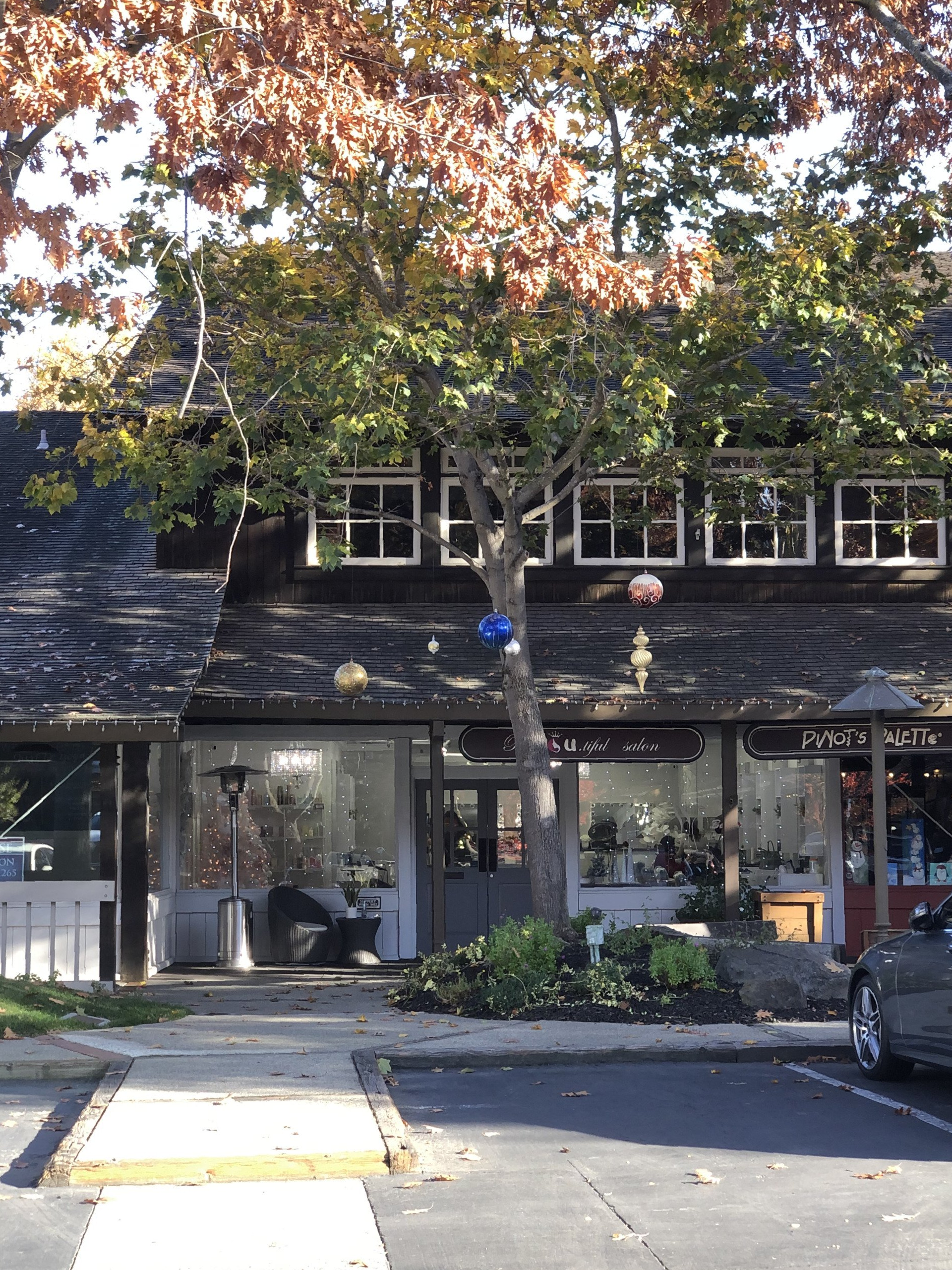 A store front with a car parked in front of it