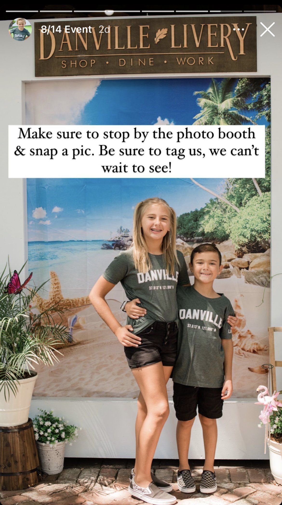 A boy and a girl are posing for a picture in front of a sign that says daville livery.