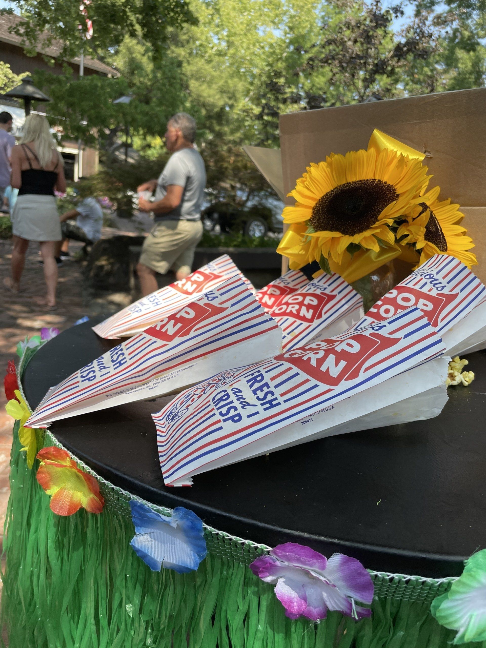 A table with paper airplanes and a sunflower on it