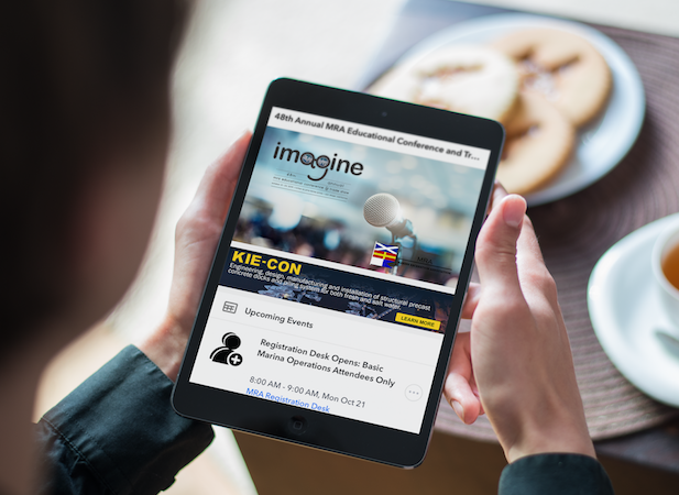 A person is holding a tablet that says imagine on it.