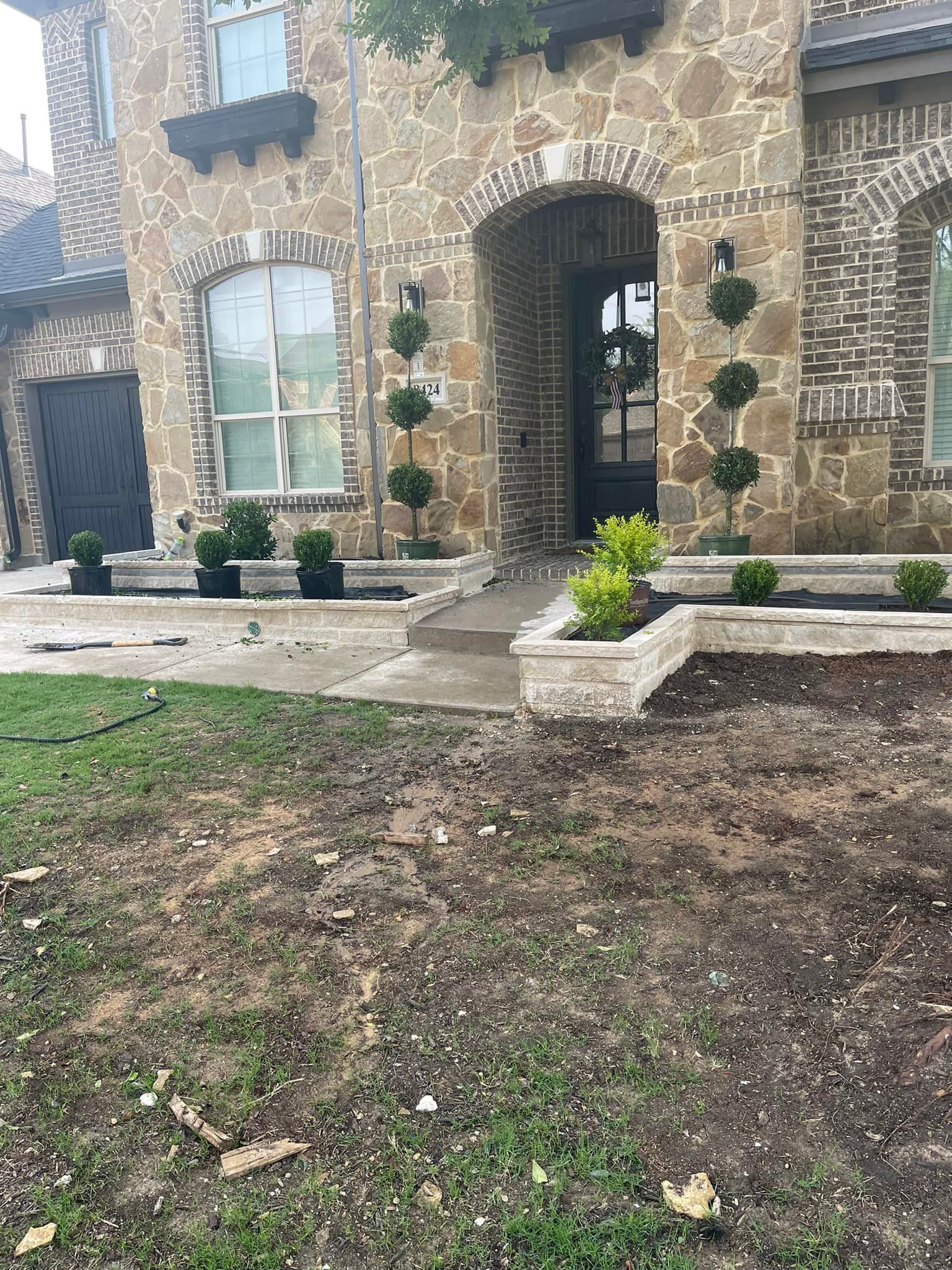A large brick house with a lush green lawn in front of it.