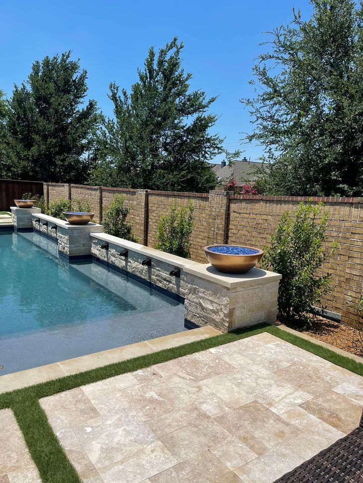 There is a large swimming pool in the backyard of a house.