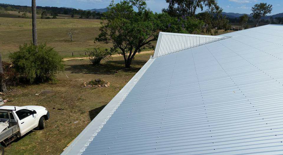 A White Truck Is Parked In Front Of A Metal Roof — House Guttering in Bauple, QLD