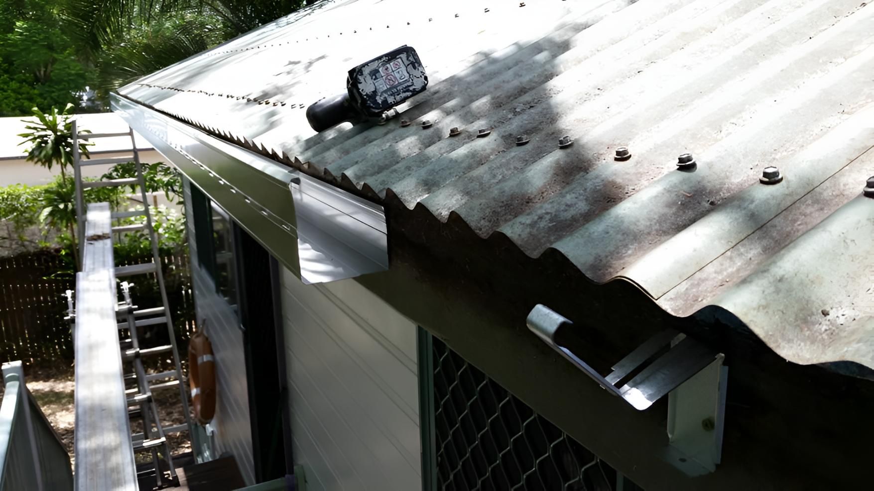 A Bottle Is Sitting On The Roof Of A Building — House Guttering in Bauple, QLD