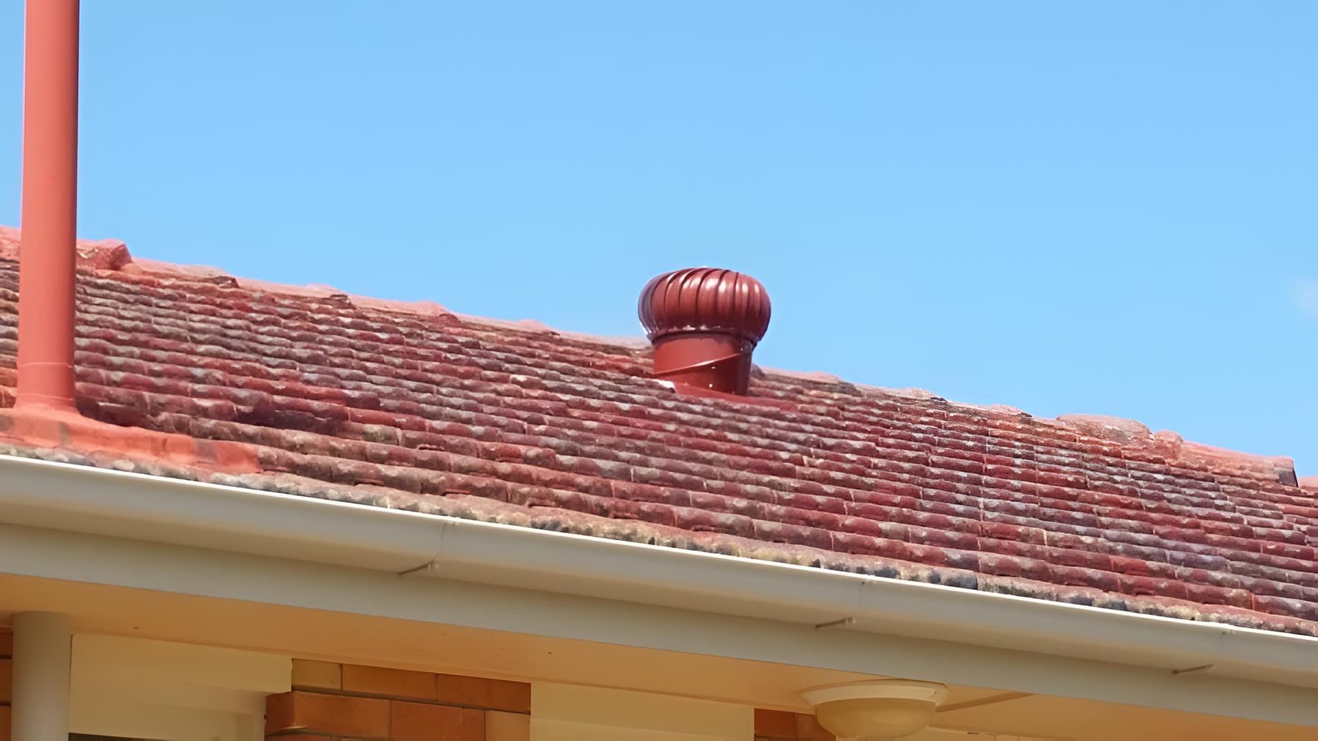 A Red Tiled Roof With A Chimney On Top Of It — House Guttering in Bauple, QLD