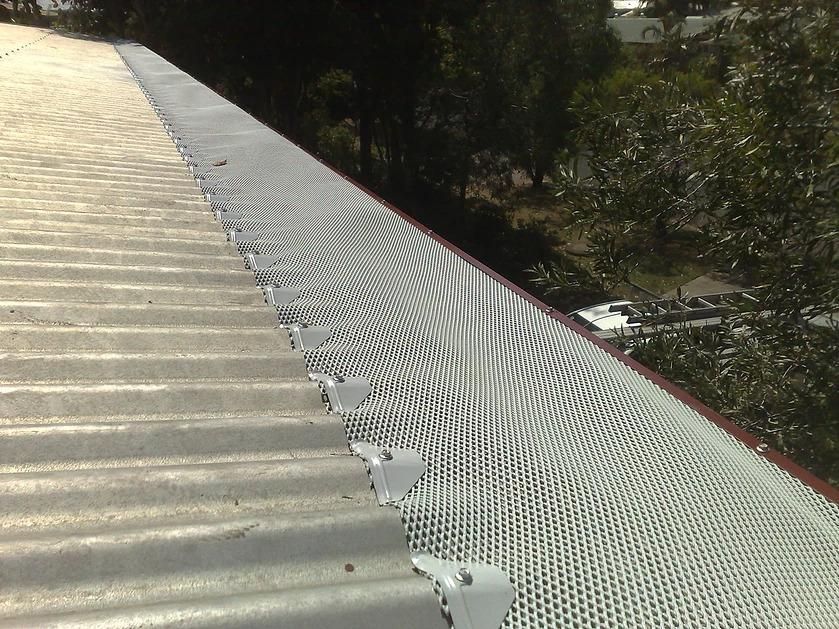 A Metal Roof With A White Mesh On It — House Guttering in Bauple, QLD