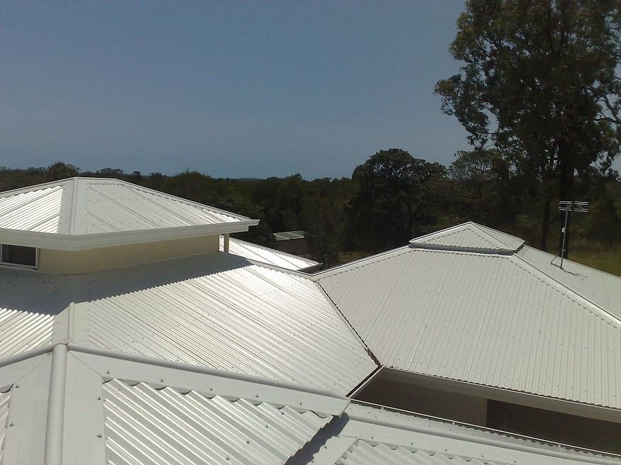 A White Roof With A Blue Sky In The Background — House Guttering in Bauple, QLD