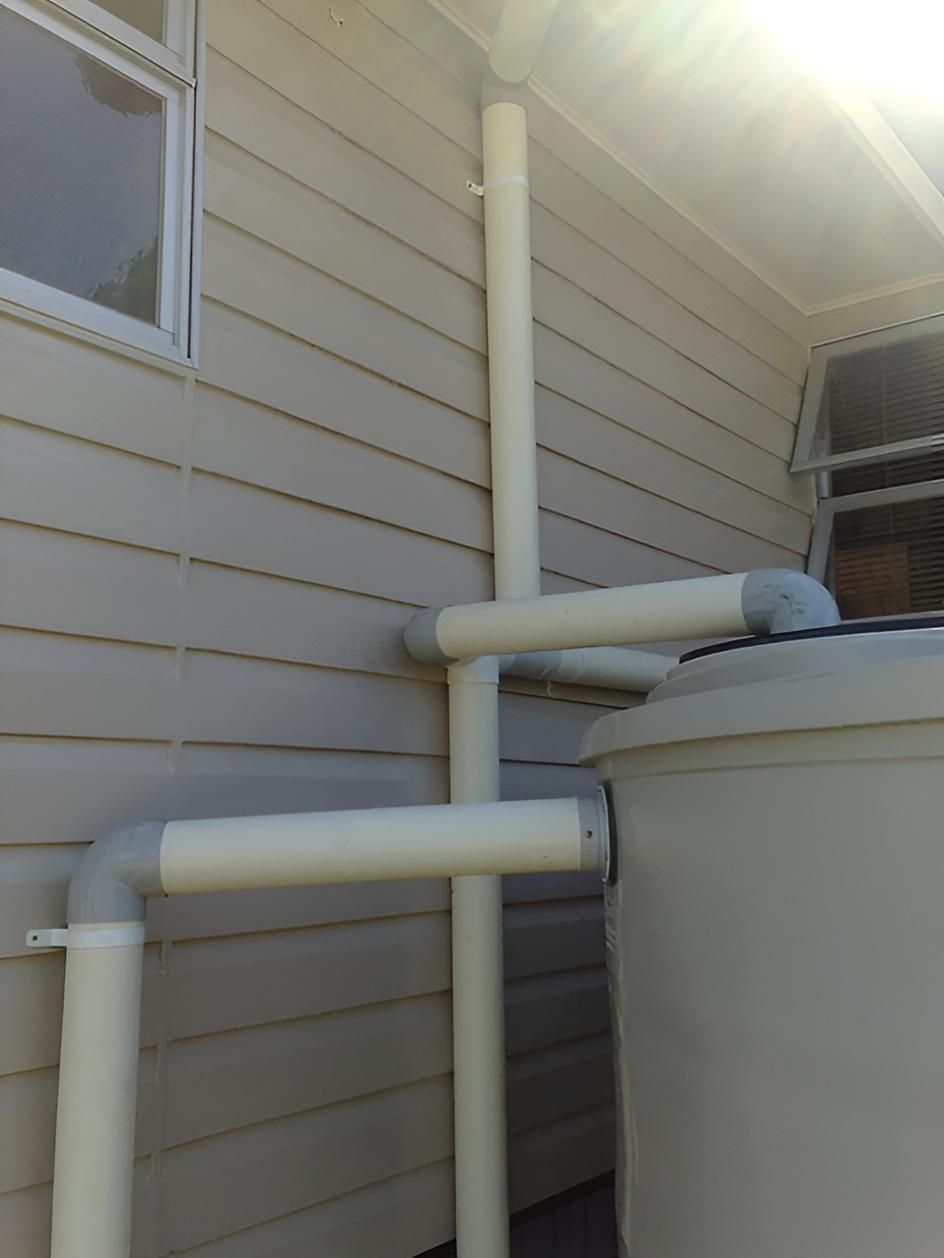 A White Pipe Is Attached To The Side Of A House — House Guttering in Bauple, QLD
