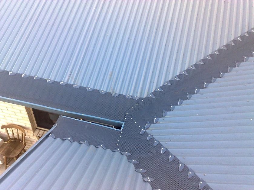 A Close Up Of A White Corrugated Metal Roof With A Gutter — House Guttering in Bauple, QLD