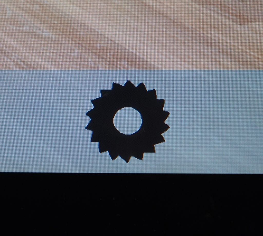 Black gear icon on a light blue background.