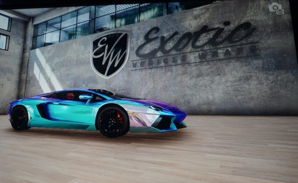 A blue and purple iridescent Lamborghini parked inside a garage with an 