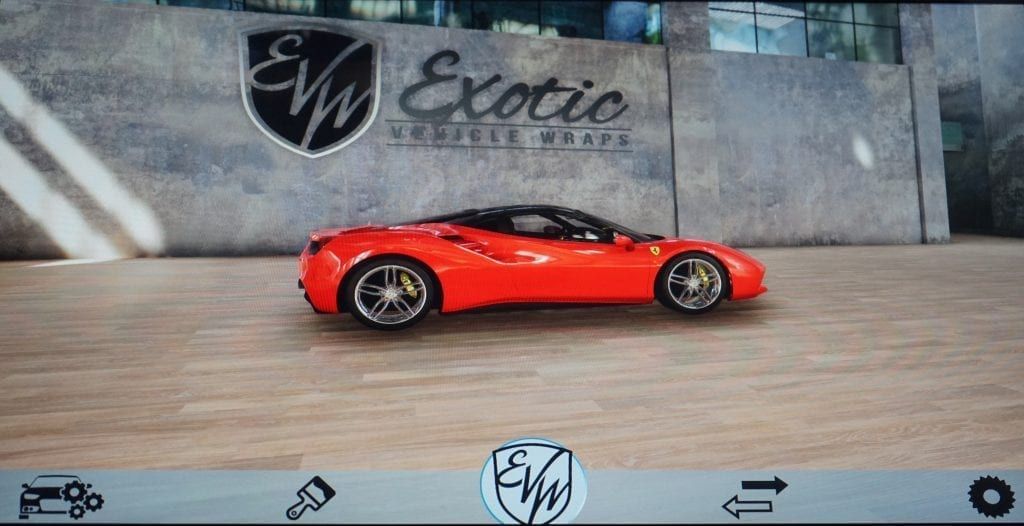 Red Ferrari sports car parked in front of Exotic Auto Repair shop, with logo on wall.