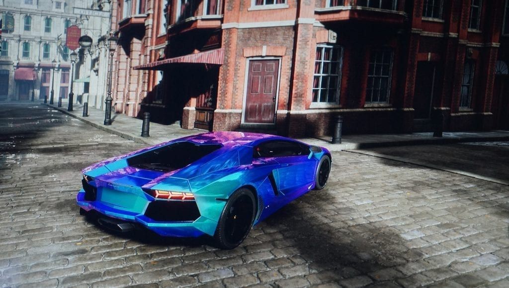 Blue Lamborghini parked on a cobblestone street in front of a brick building.