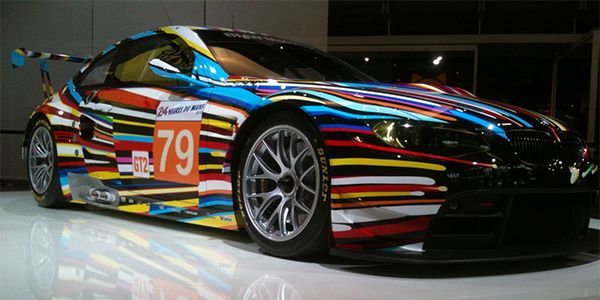 Race car with colorful horizontal stripes and number 79 on display.