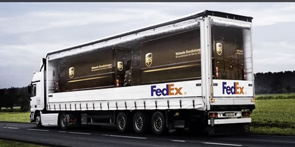 FedEx truck, revealing a UPS truck inside. The truck is on a highway.