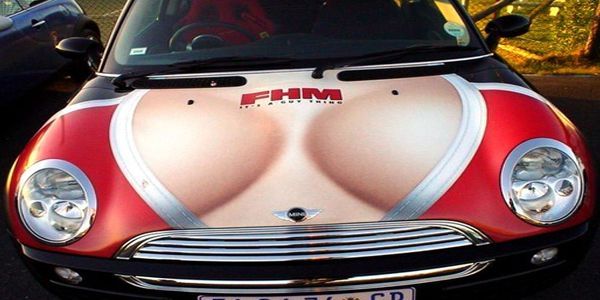 Mini Cooper car hood with a graphic of a woman's chest, advertising