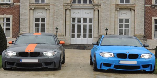Black BMW sedan with tinted windows and black wheels.