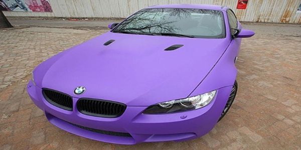 Black BMW sedan with tinted windows and black wheels.