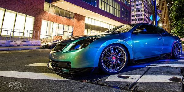 Black BMW sedan with tinted windows and black wheels.