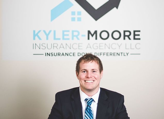 A man in a suit and tie is smiling in front of a window