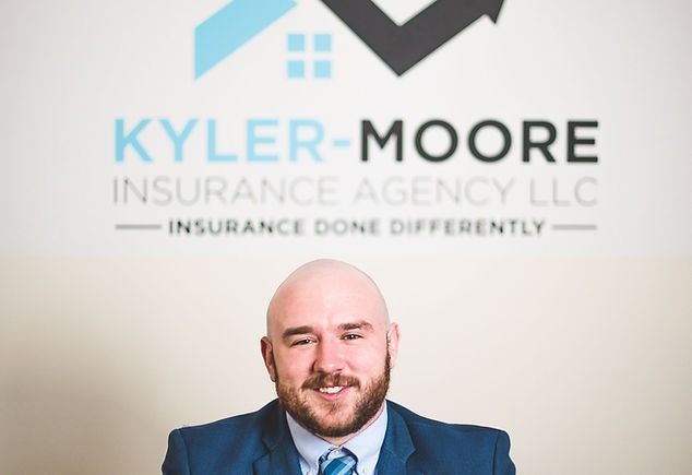 A man in a suit and tie is smiling in front of a window