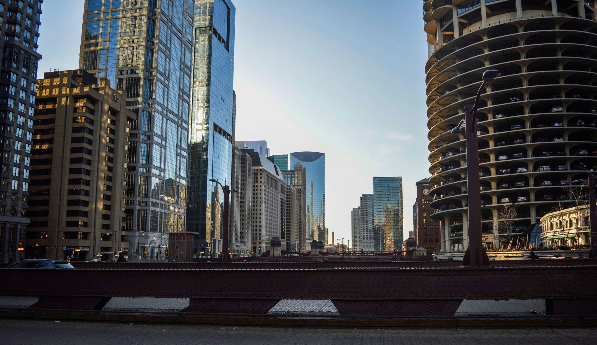 City skyline with tall buildings, some under construction, on a sunny day.