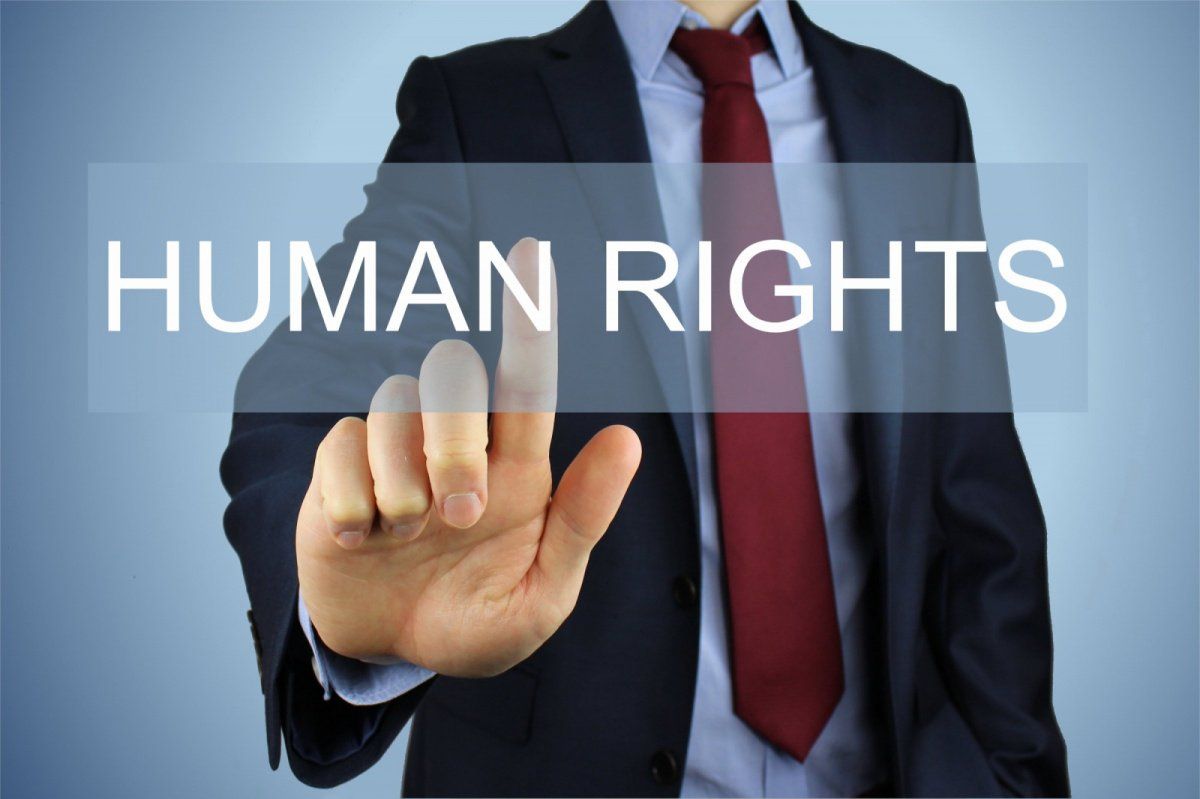Decorative image of a man pressing a button that says human rights