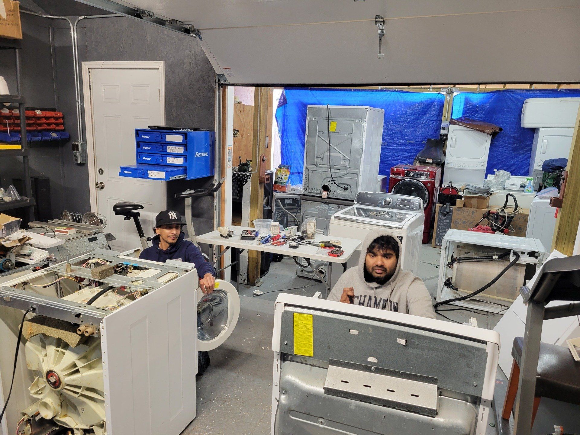 Hands of repairman using T-type wrench,screwing the nut of the washing machine after repairing or removing it to clean the drum,repair of household electrical appliances or cleaning services concept