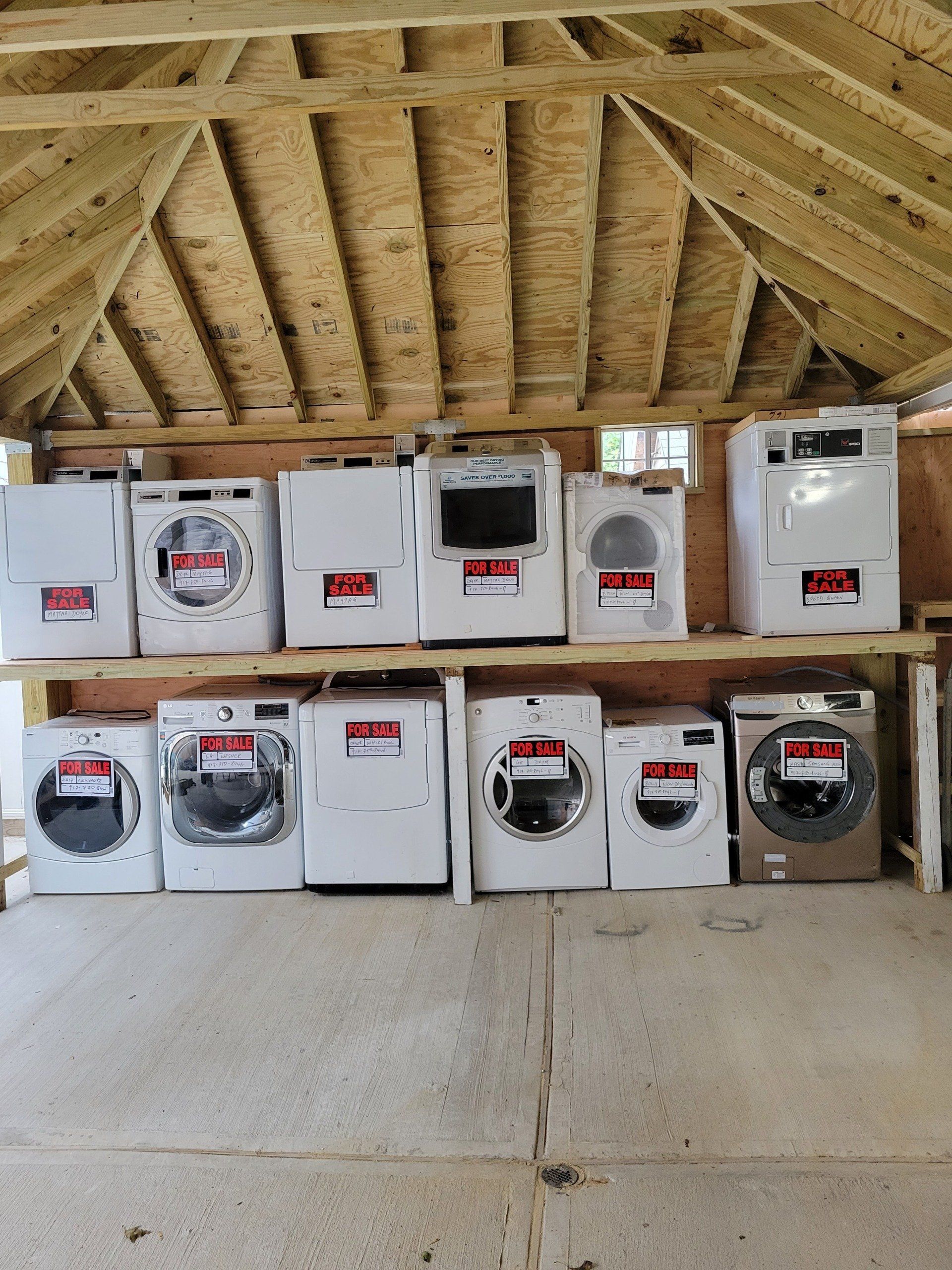 working man plumber repairs a washing machine in laundry