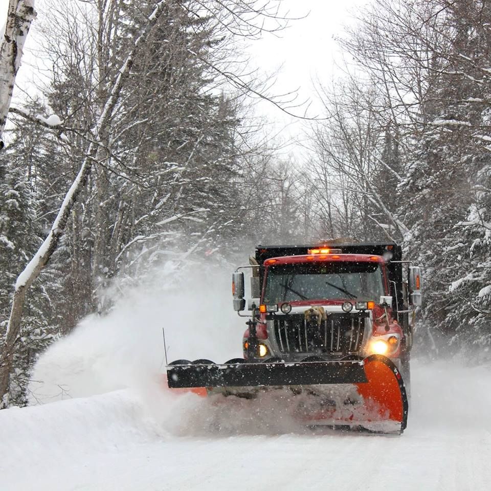 A snow plow clearing Pinkham Road in Burke, Vermont