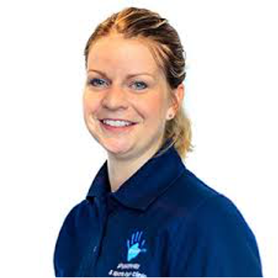 A man in a suit and tie is smiling for the camera.