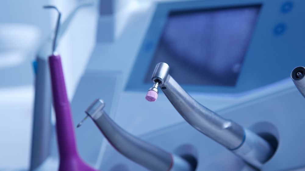 A dentist is talking to a patient in a dental office.
