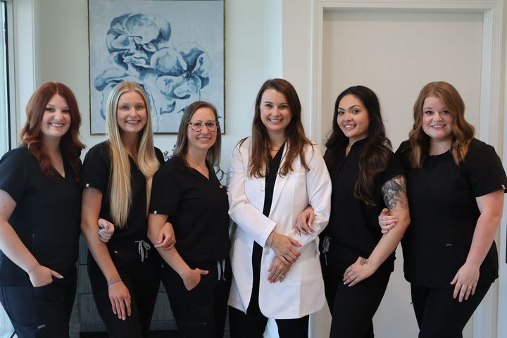 A group of women are posing for a picture together.