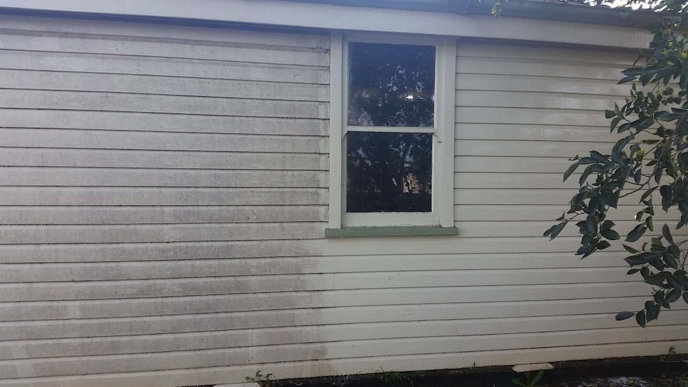 A White House With a Window and a Tree in the Background — AD House Wash & Gutter Cover in East Toowoomba, QLD