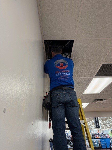 A man wearing a blue shirt that says ' let 's fix it ' on it