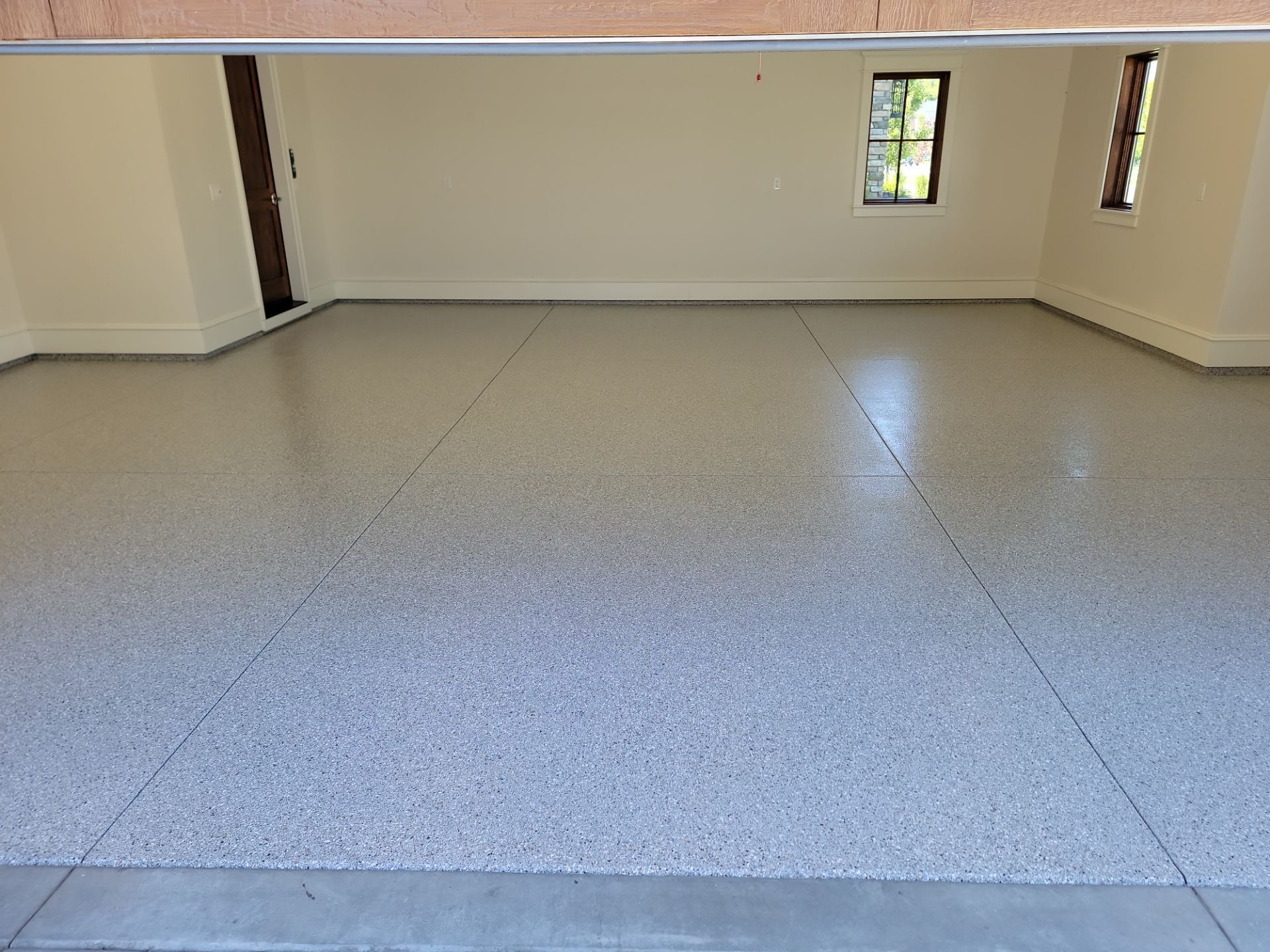 A garage with a gray floor and white walls