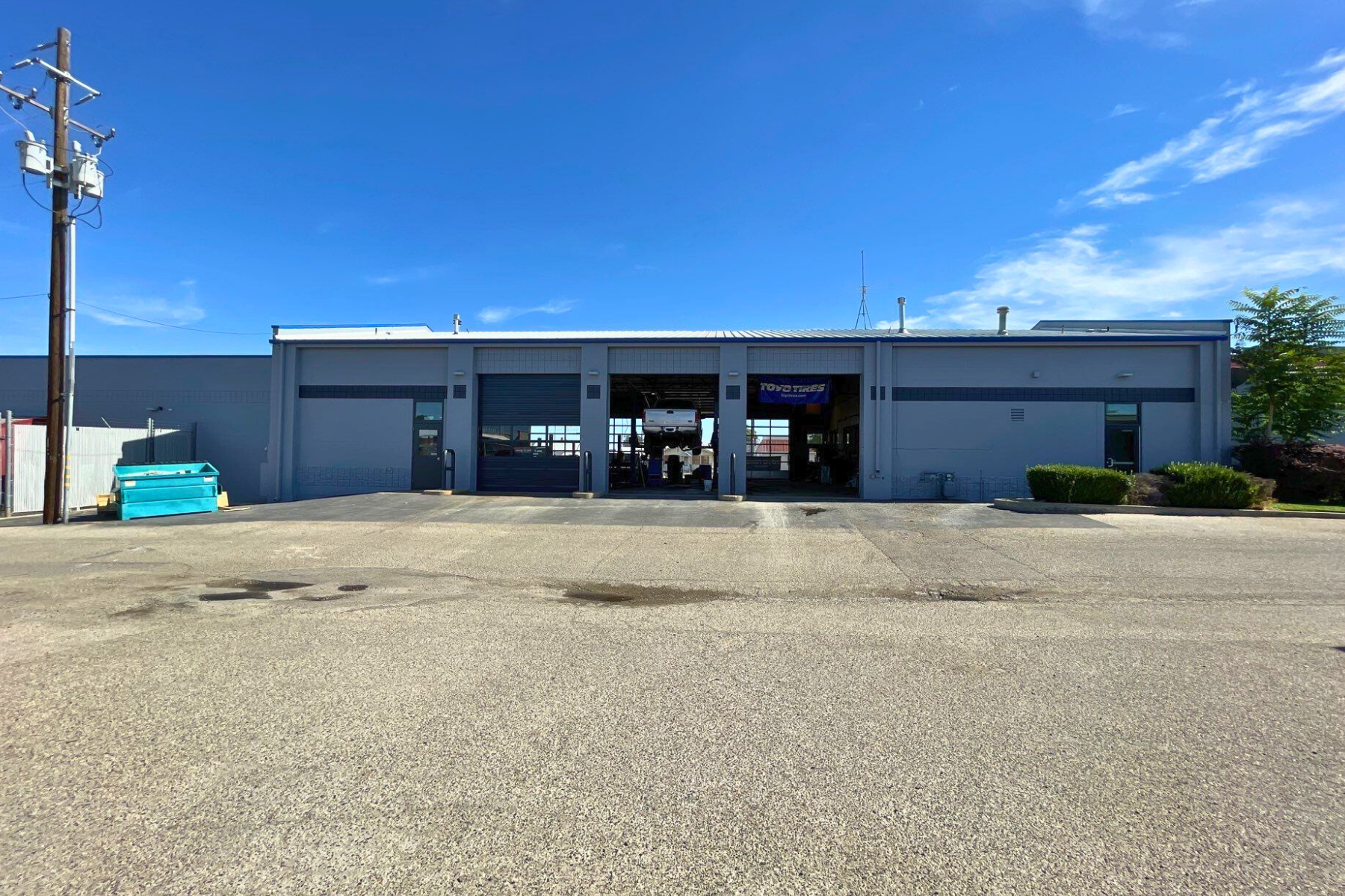 A large building with a lot of windows and a blue sky in the background.