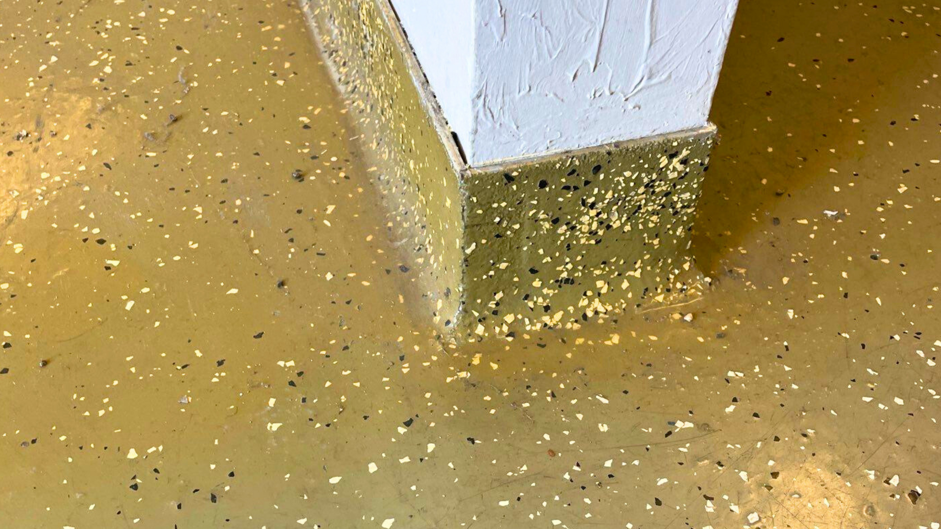 an old commercial epoxy floor coating that is visably yellowing, chipping and peeling 