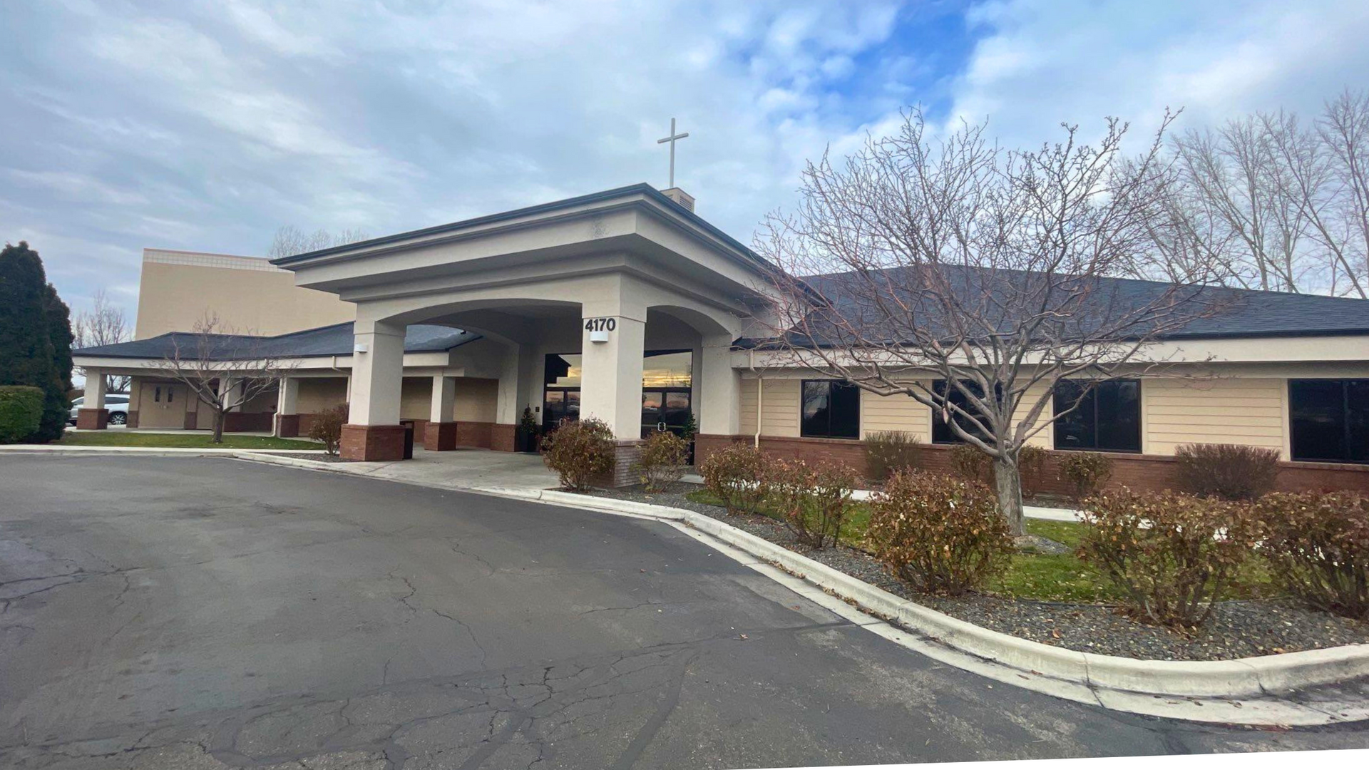 Front exterior of a commercial church building in Boise with light stucco, brick accents, and well-m