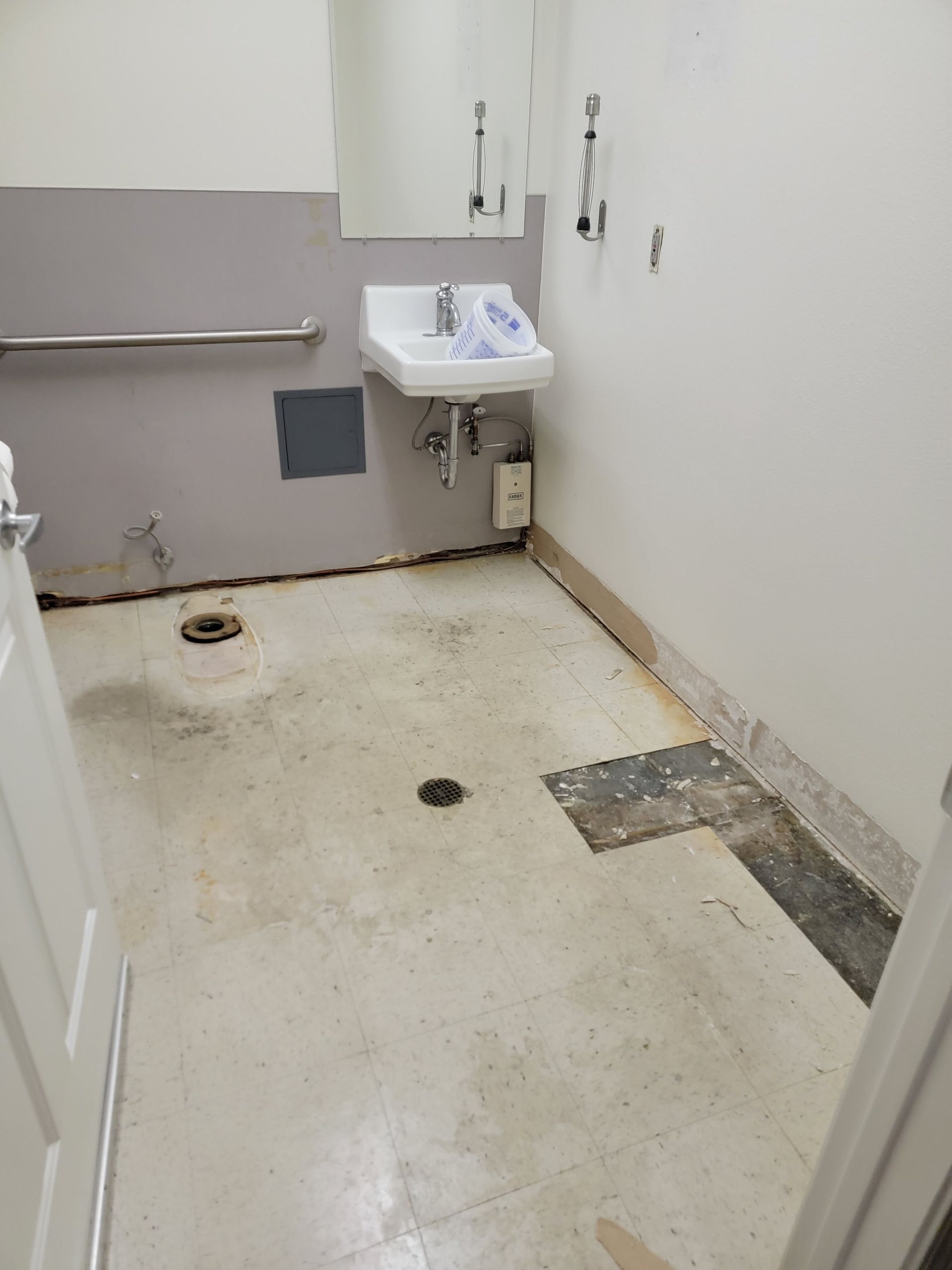 A bathroom with a sink and a toilet in it