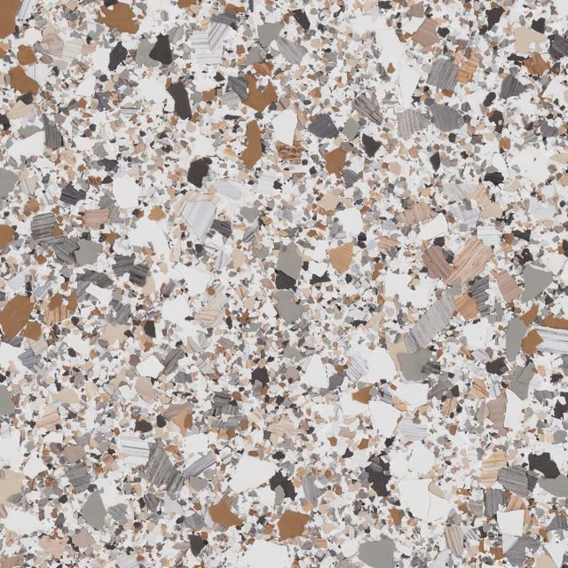 A close up of a granite counter top with a lot of different colored rocks.